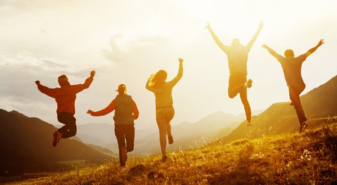 Group of happy friends run and jump